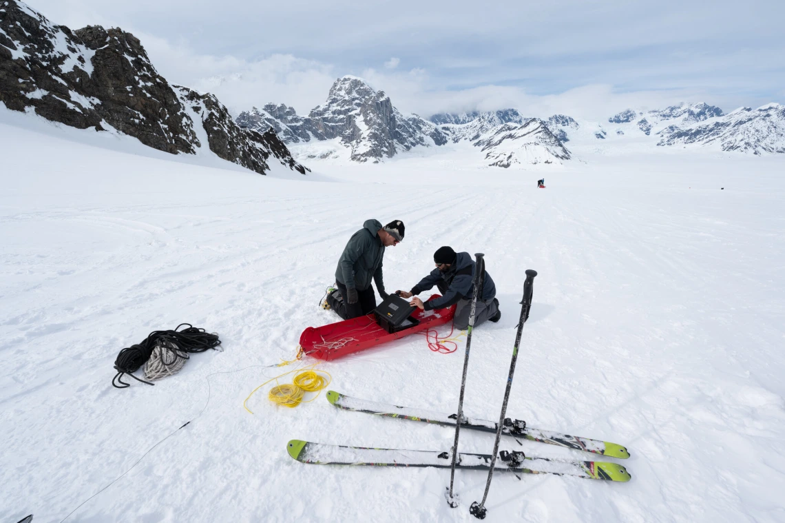 Martin Truffer, left, a glaciologist at the University of Alaska Fairbanks, and Brandon Tober, then a graduate researcher at the University of Arizona, set up the radar system on the glacier.